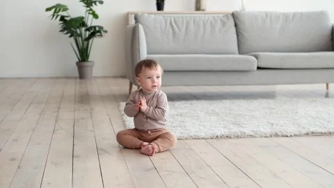 Adorable Toddler Clapping Hands Sitting on the Floor Video stock 254438576