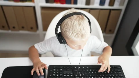 Adorable toddler student using computer doing ok gesture with thumb up at c.. Video stock 223746242