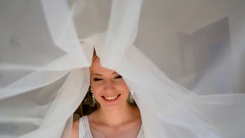 Adorable young bride is getting ready in the morning at home. The bride getting Видео 127573075