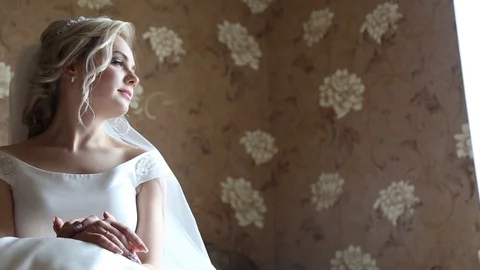 Adorable young bride is getting ready in the morning at home. The bride getting Stock-Footage 127952015