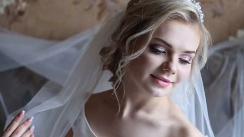 Adorable young bride is getting ready in the morning at home. The bride getting Stock-Footage 127952427