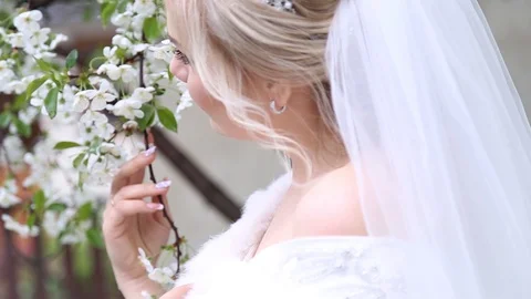 Adorable young bride is getting ready in the morning at home. The bride getting Stock-Footage 127952573