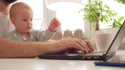 Adorable Young Caucasian Toddler Girl Sitting with Father Working from Home Stock Footage