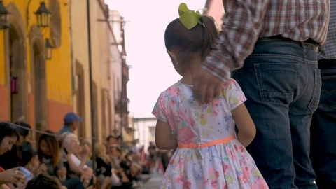 Adorable young Mexican girl holding hands and walking with her father Stock Footage
