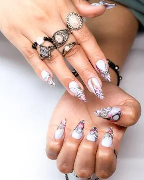 Adorned hands featuring bracelets, rings, and beautifully painted nails. Stock Photos