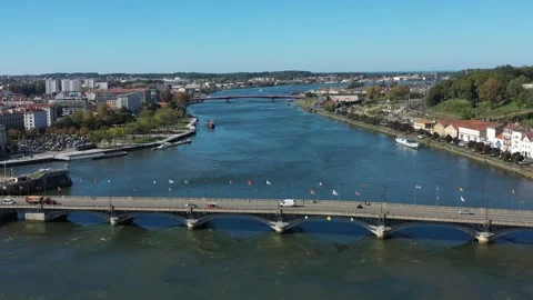 Adour River and Saint-Esprit bridge, Bayonne in France. Aerial drone panoramic Stock Footage 297470809