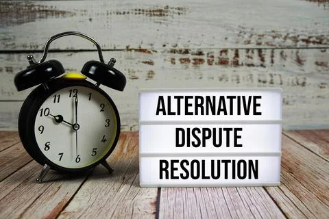 ADR Alternative Dispute Resolution text on light box with alarm clock on wo.. Foto stock
