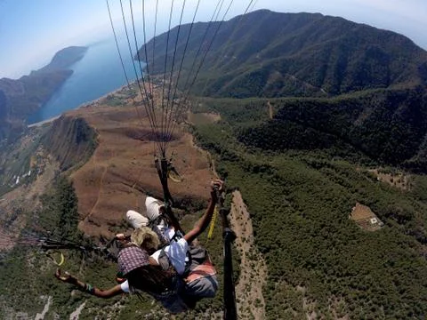 ADRASAN, TURKEY - JUNE 27, 2017: Paraglaiding fly above laguna Stock Photos