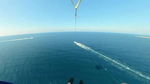 An adrenaline filled water activity. Parasailing being towed by a fast Stock-Footage 219949297