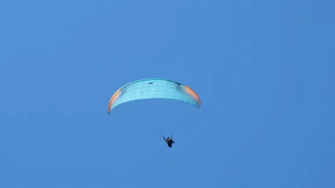 Adrenaline parasailing in clear sky. Video stock 236333738