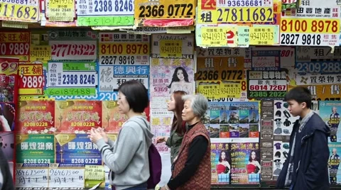 Ads pasted on the wall in the central district of Kowloon in Hong Kong. Stock Footage 48951118