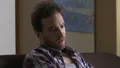 Adult alcoholic sitting on couch and talking to bottle of beer, degradation HD Footage