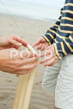 Adult And Child Setting Up Crickets Stumps