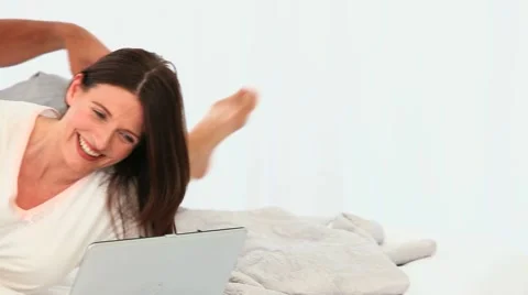 Adult couple laughing in front of a laptop Stock Footage