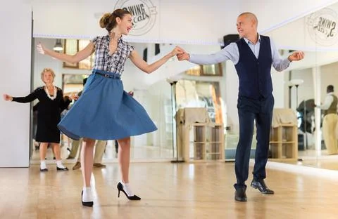 Adult dancing couple enjoying active swing Stock Photos