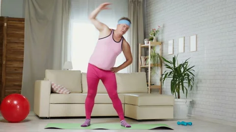 Adult Fat Man Doing Exercise At Home In A Pink T-shirt And Pink Women Pants Stock Footage 116341989