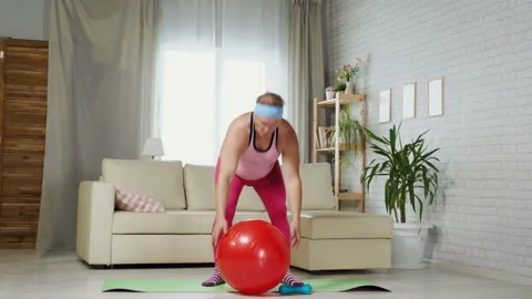 Adult Fat Man Doing Exercise At Home In A Pink T-shirt And Pink Women Pants Stock Footage 116354443