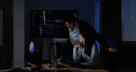 Adult female technology professional and male colleague discuss computer Stock Footage 343732053