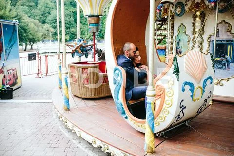 Adult man and woman on a carousel Stock Photos
