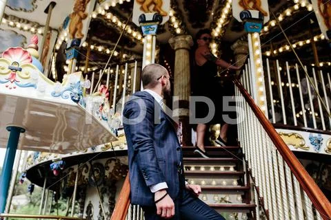 Adult man and woman on a carousel Stock Photos