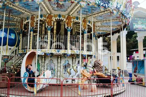 Adult man and woman on a carousel Stock Photos