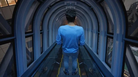 Adult man from back using escalator stairs with no other people Stock Footage 146145243
