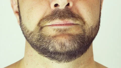 Adult man with a beard. He eats a banana. Close-up. Vídeo Stock 107500618