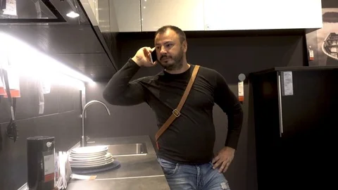 Adult man with a beard uses a mobile phone smartphone Stock Footage