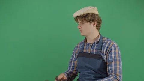 Adult man carpenter testing a drill on the green screen studio isolated shot Stock Footage 119808151
