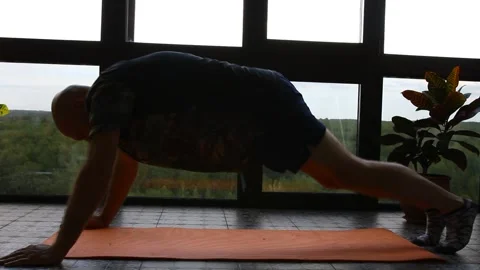 Adult man does a plank exercise in home interior. Stock Footage 283842128