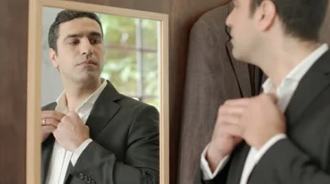 Adult man dressing up and looking at mirror Stock Footage