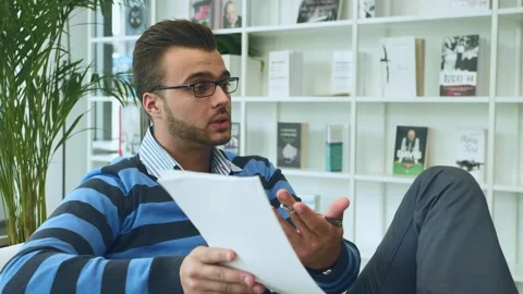 Adult Man Gesturing and Talking with Papers in Modern Office Warsaw Stock Footage 340265357