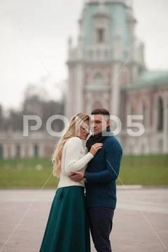 Adult man hugs his beloved woman autumn on a walk in the city Stock Photos