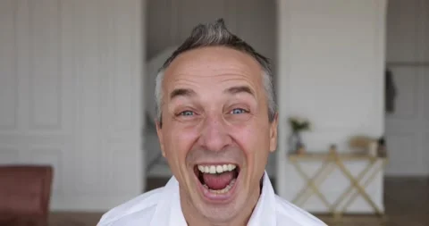 Adult man laughs very emotionally with his mouth open Stock Footage