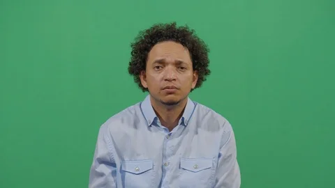 Adult man looking scared at the camera like the danger is coming from the viewer Stock Footage 117721076
