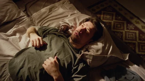Adult Man Lying down on Bed Struggling with Anxiety while Getting up in Morning Stock Footage 330602754