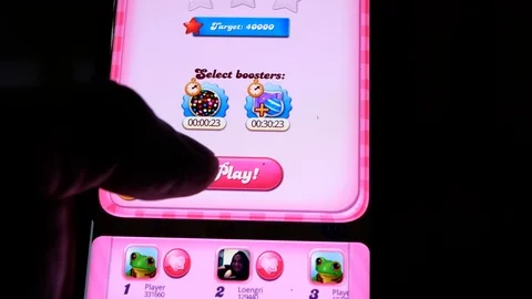 Adult man playing Candy Crush saga game on smartphone Stock Footage