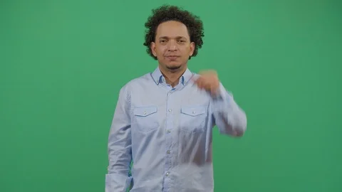 Adult man protesting making a tight fist sing studio isolated shot against green Stock Footage 117718404