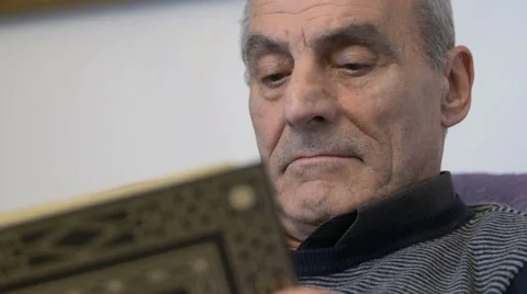 Adult man reading a book, hardcopy, grey hair Stock-Footage 59113995