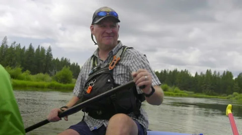 Adult man rowing in raft Stock Footage 59707228