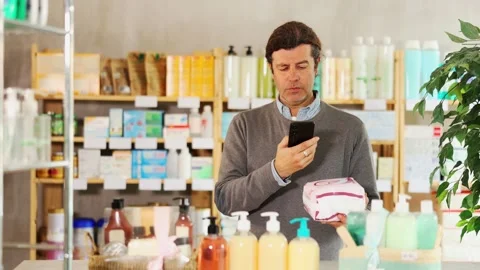 Adult man scanning qr code of feminine pads Video stock 308960024