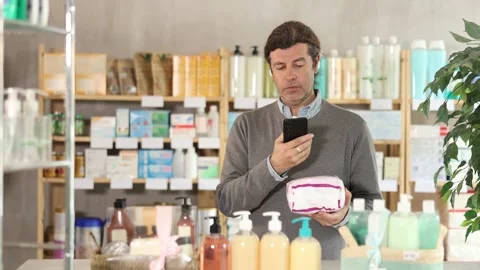 Adult man scanning qr code of feminine pads Stock Footage 318941249