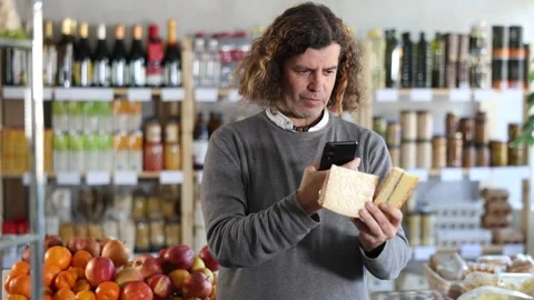 Adult man scanning qr code for cheese Stock Footage 329541585