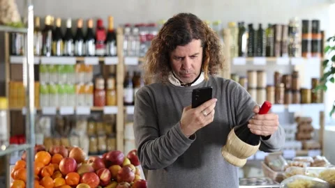 Adult man scanning qr code of wine Stock Footage 332734427