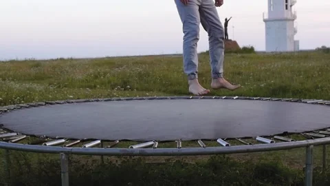 Adult man shows acrobatic tricks on a trampoline, slow motion Stock Footage