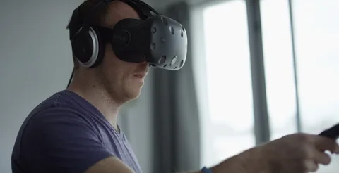 Adult man using Virtual Reality headset Stock Footage 106848894