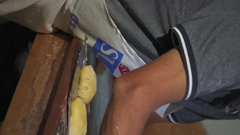 An adult man working in a bakery Stock Footage 229478889