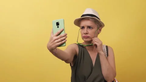 Adult model with multi-colored straw hat bag on yellow background. Blonde Stock Footage 143154675