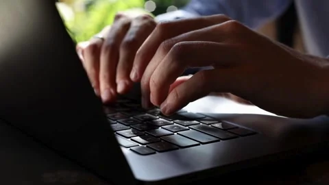Adult programmer coding to develop a program at his office table during work Stock-Footage 334586700