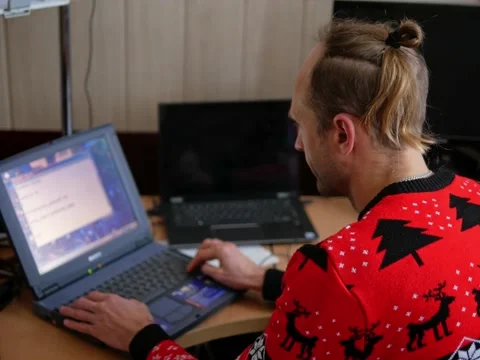 Adult programmer writing code on his old laptop in his room Stock Footage 224138083